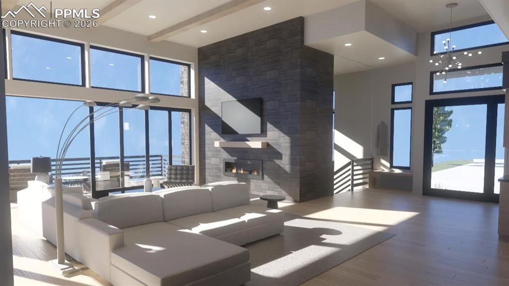 Image 4 of 45: Front entry with iron pivot door, stone gas linear fireplace