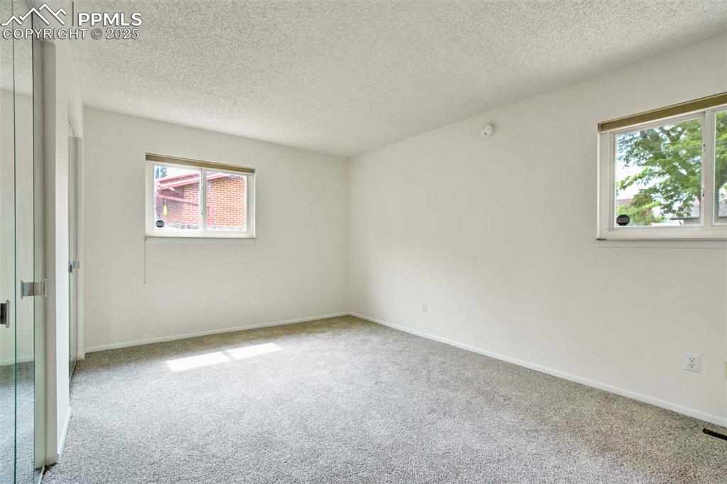 Image 15 of 45: Primary room featuring carpet flooring and a textured ceiling