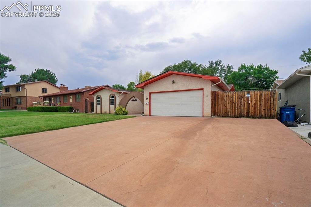 Image 2 of 45: View of front of home with concrete driveway, an attached garage, and stucc