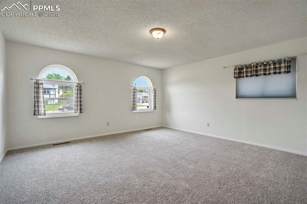 Image 20 of 45: Bedroom with carpet and a textured ceiling