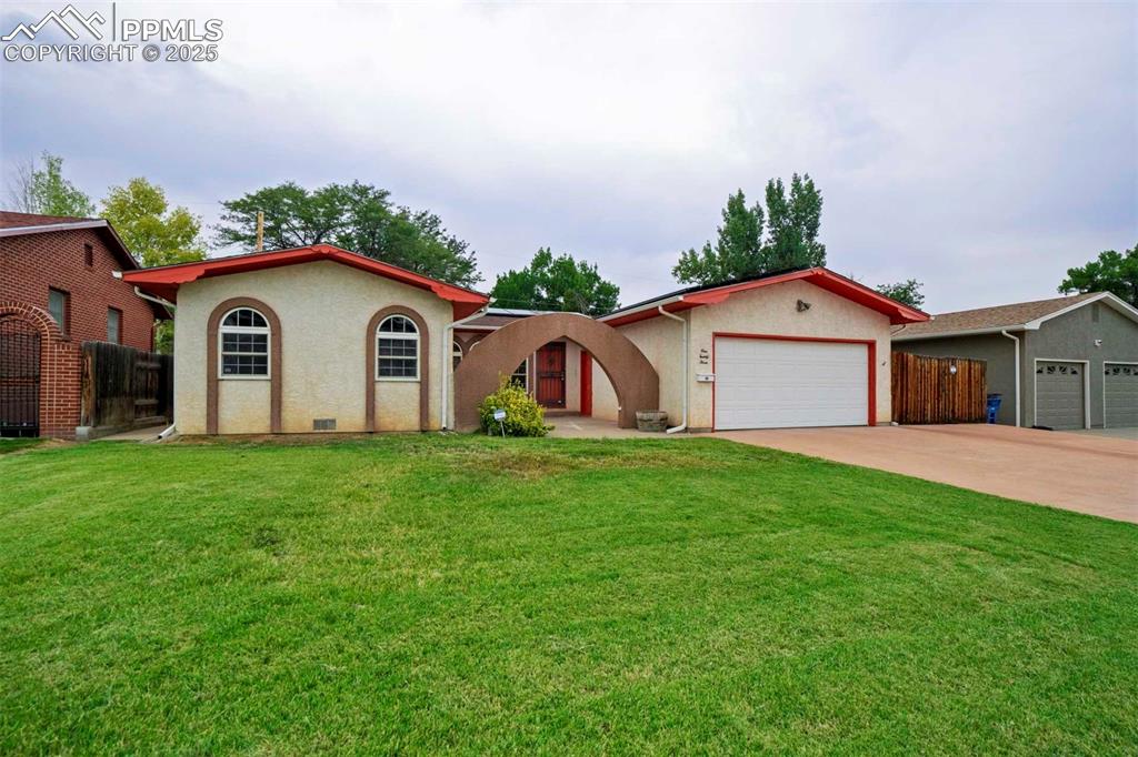 Image 3 of 45: View of front of house with driveway, an attached garage, and stucco siding