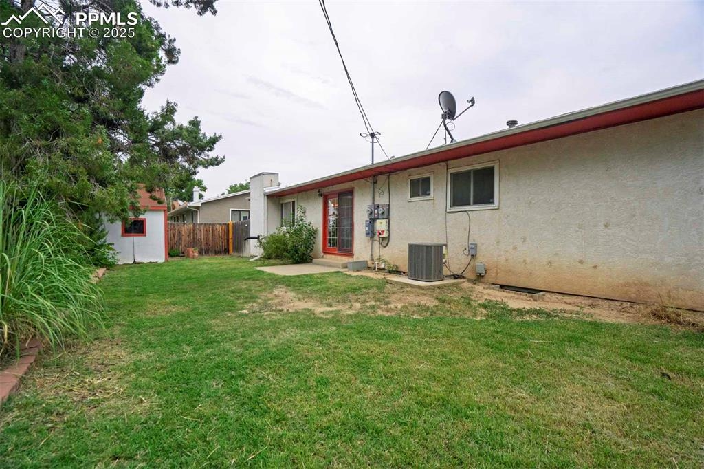 Image 41 of 45: Back of property featuring a patio area, stucco siding, and an outdoor stru
