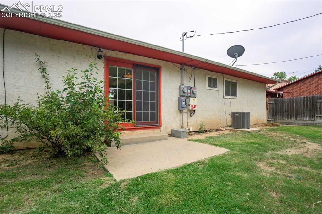 Image 42 of 45: Rear view of property featuring stucco siding and a patio