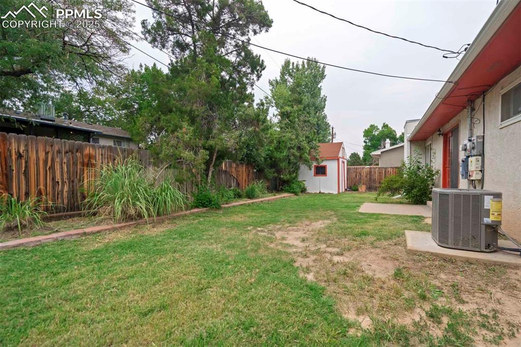 Image 45 of 45: Fenced backyard featuring a storage shed