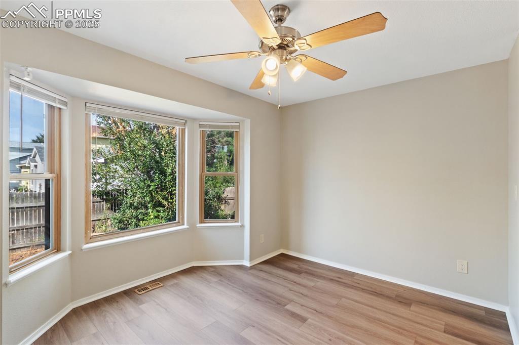 Image 10 of 31: Spare room featuring light wood-style flooring and ceiling fan