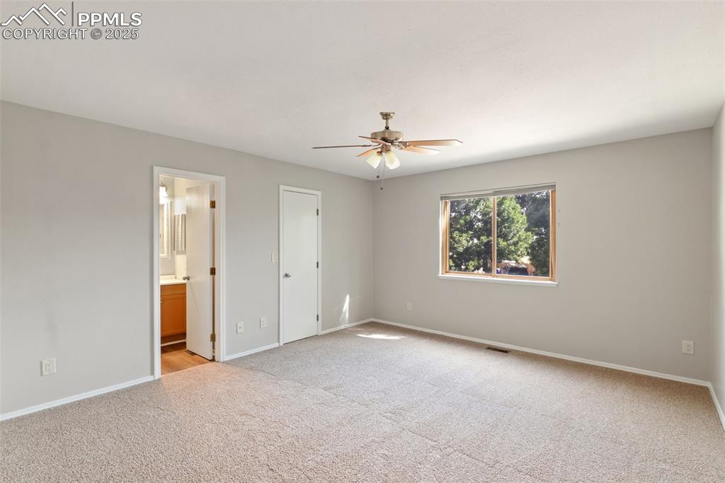 Image 14 of 31: Unfurnished bedroom featuring light carpet, ensuite bathroom, and a ceiling