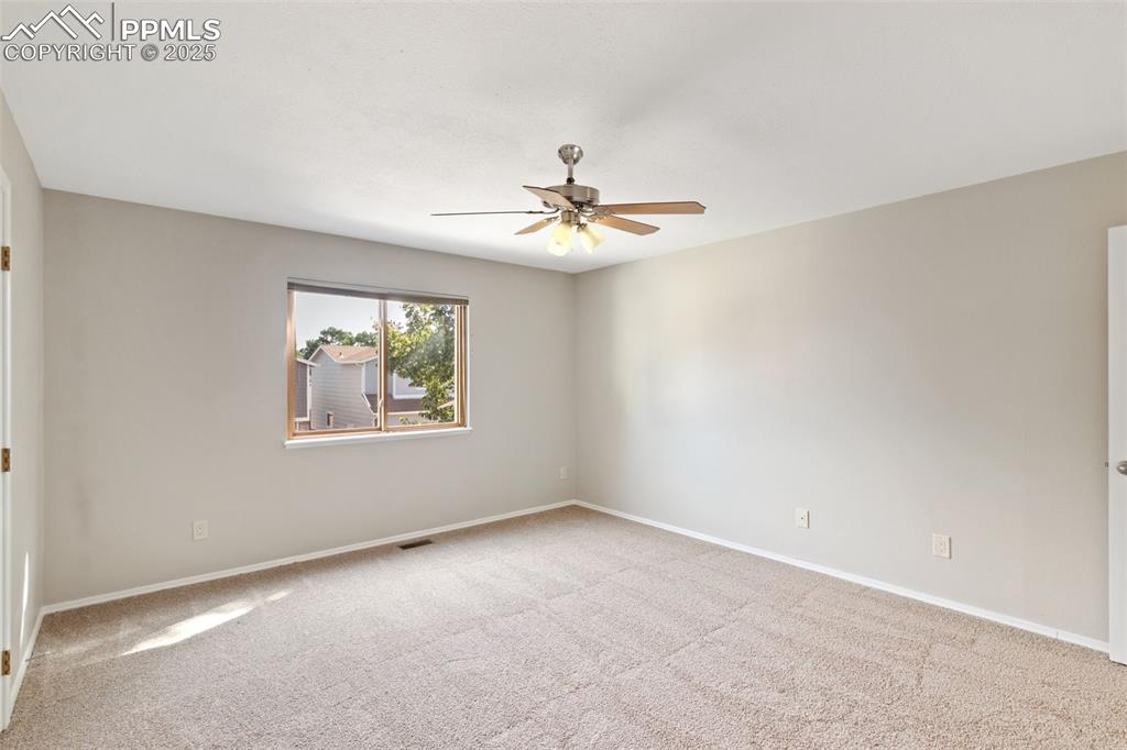 Image 16 of 31: Unfurnished room featuring ceiling fan and carpet flooring