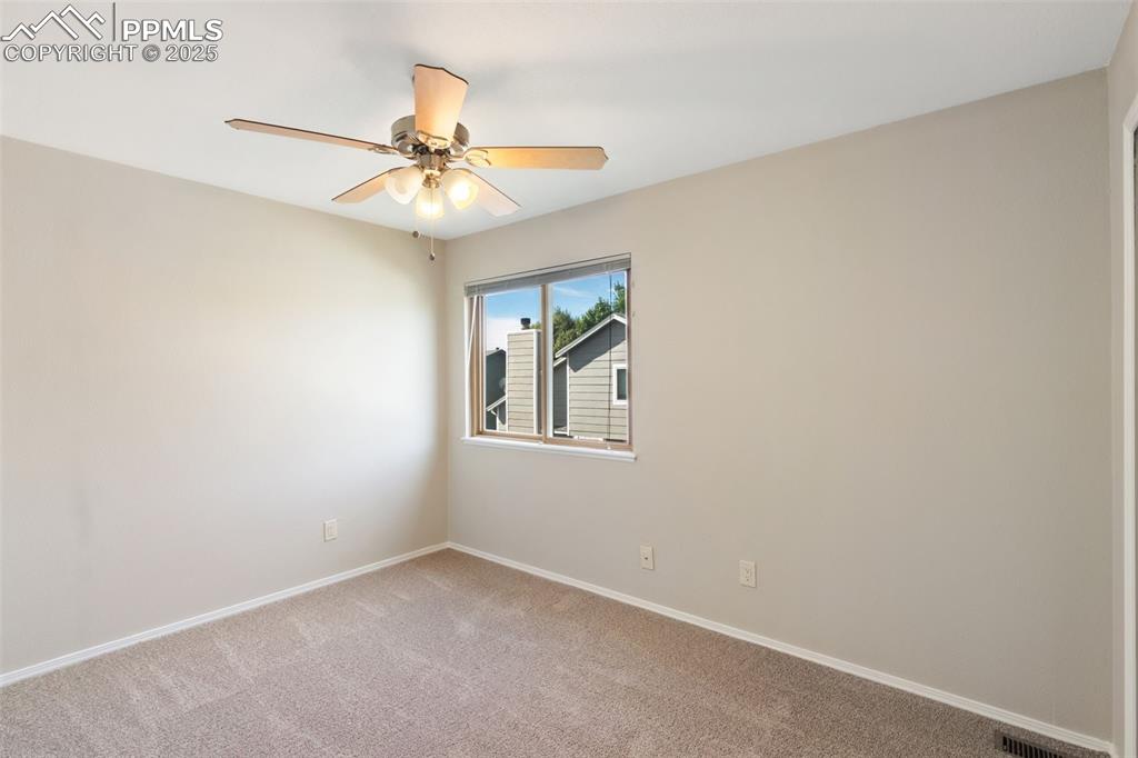 Image 18 of 31: Unfurnished room featuring light carpet and a ceiling fan