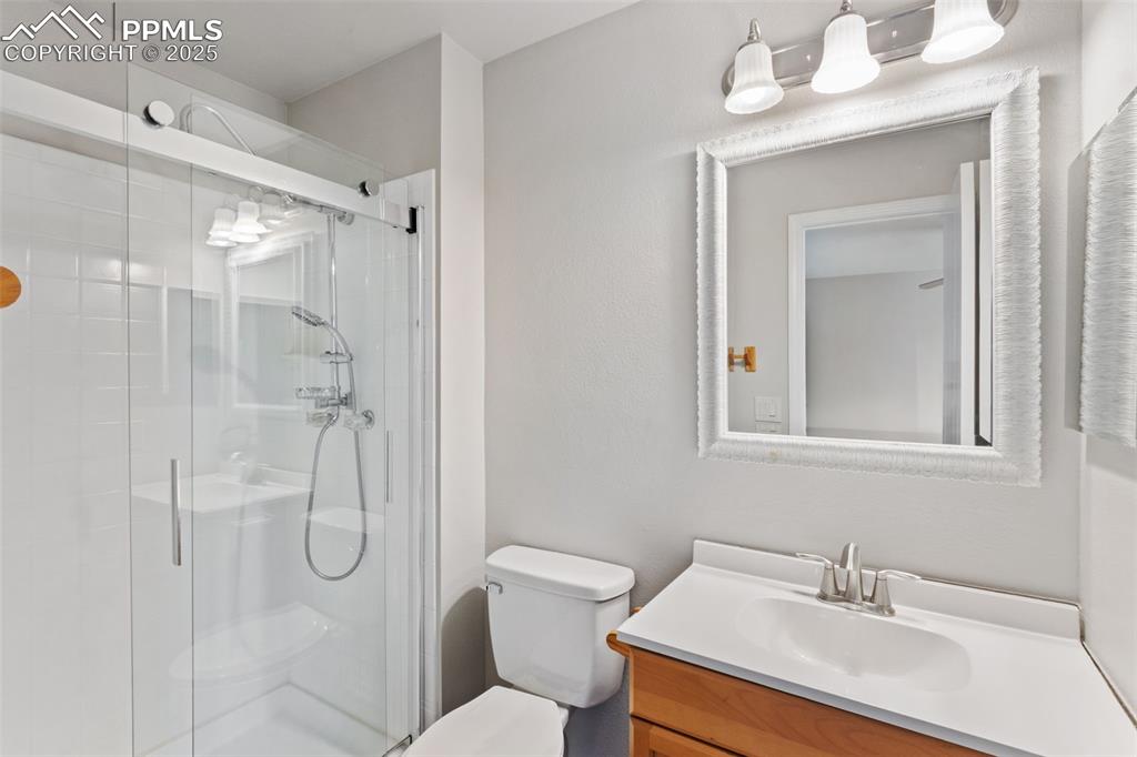 Image 22 of 31: Bathroom featuring vanity and a shower stall