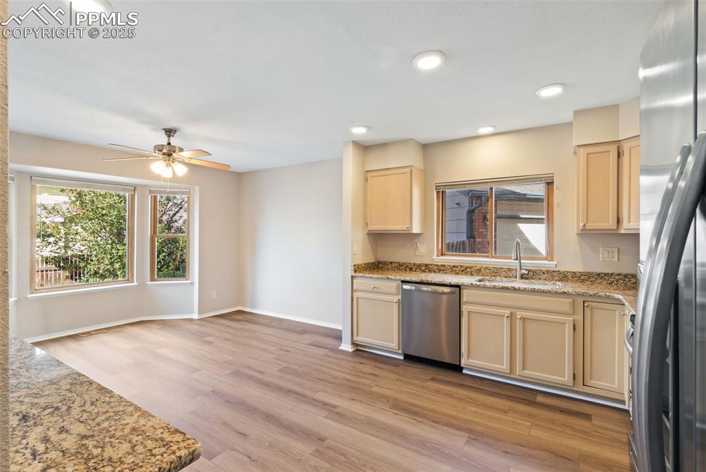 Image 8 of 31: Kitchen featuring healthy amount of natural light, appliances with stainles