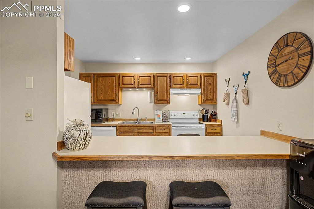 Image 11 of 23: The open-concept layout connects the living area to the kitchen and dining 