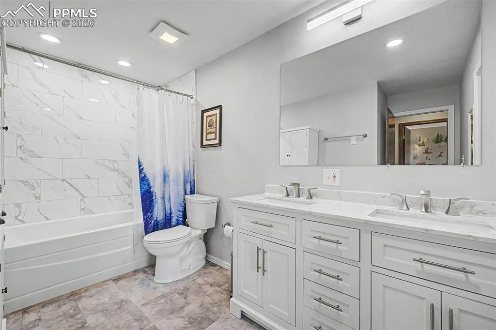 Image 18 of 23: The primary bedroom is a peaceful retreat with dual closets, a ceiling fan 
