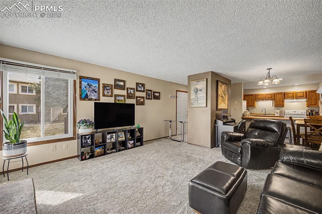 Image 7 of 23: The hand-laid stone fireplace with its rustic wood beam mantle is the unden