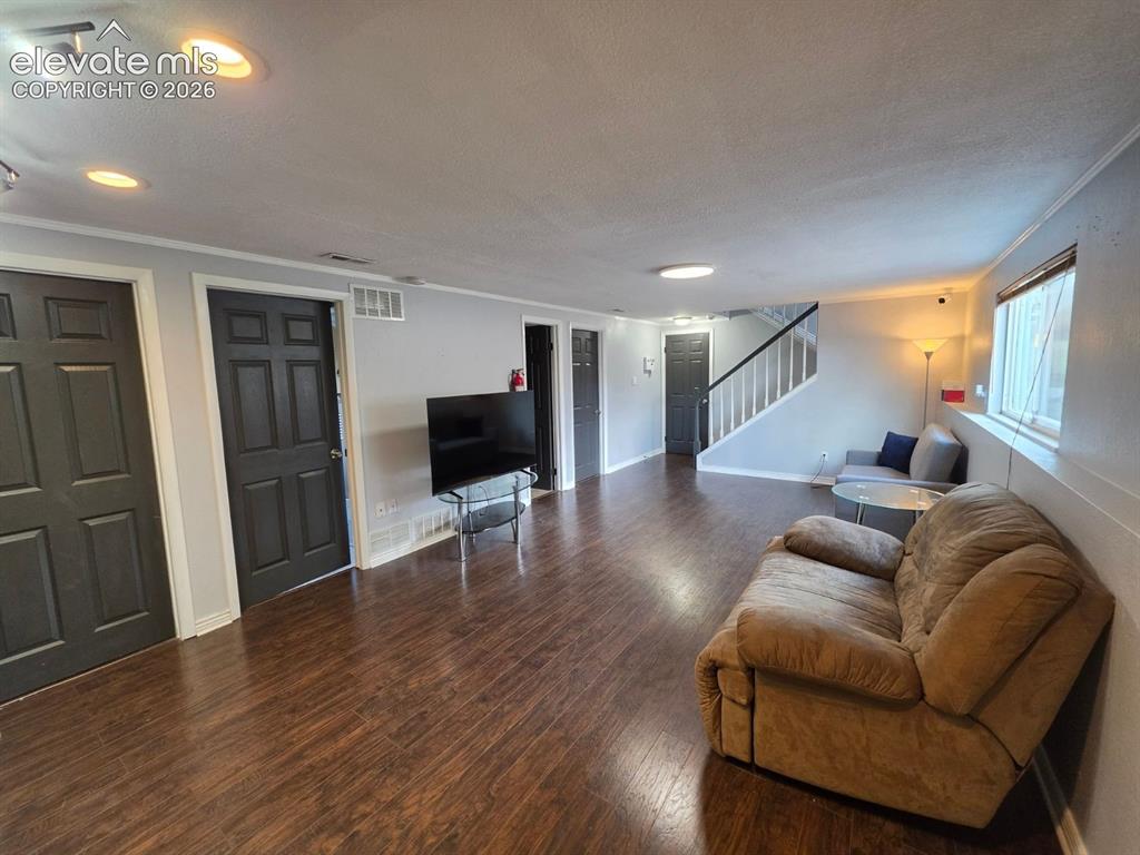 Image 10 of 18: Warm and welcoming family room with plenty of room to relax
