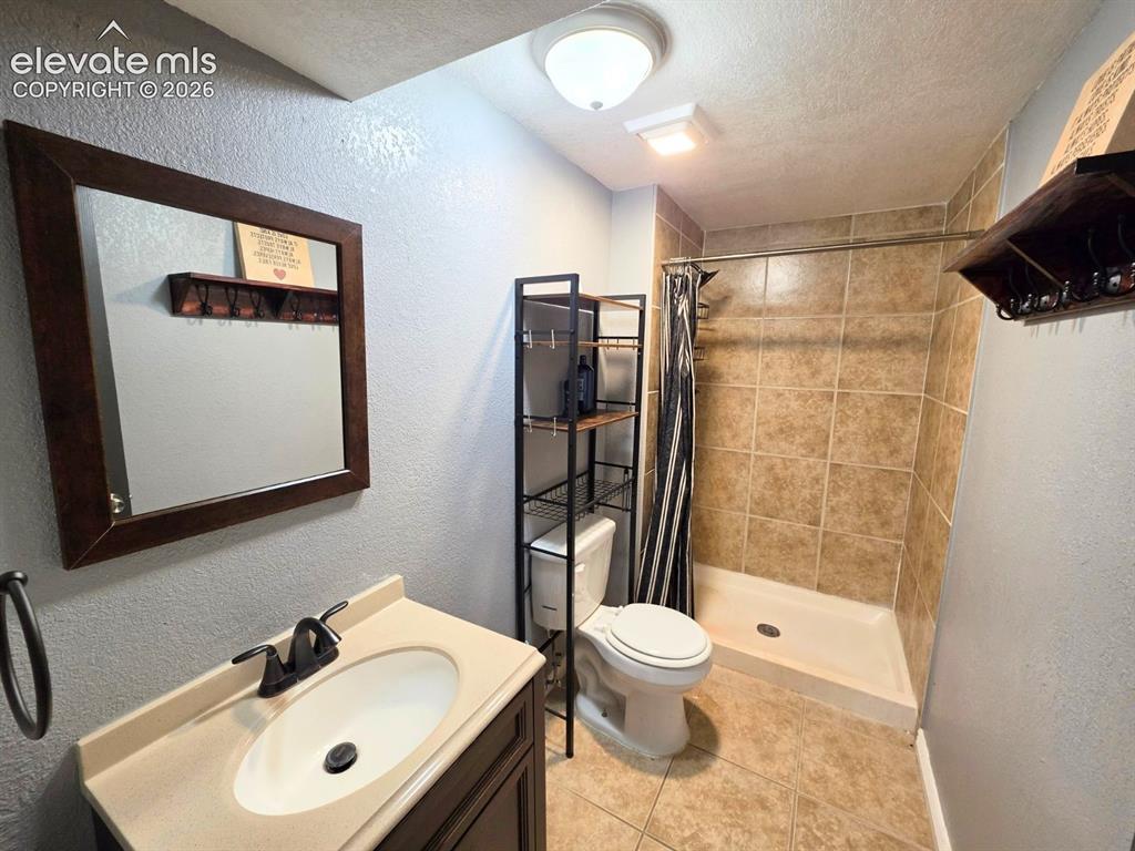 Image 11 of 18: Bathroom featuring a stand-up shower