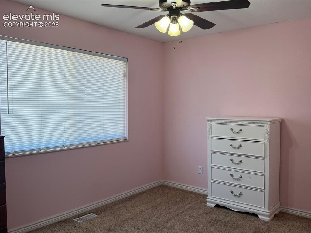 Image 6 of 18: Well-sized bedroom with carpet flooring