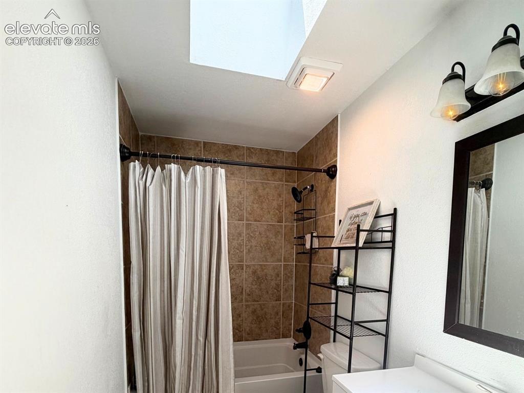 Image 7 of 18: Full bathroom with a skylight