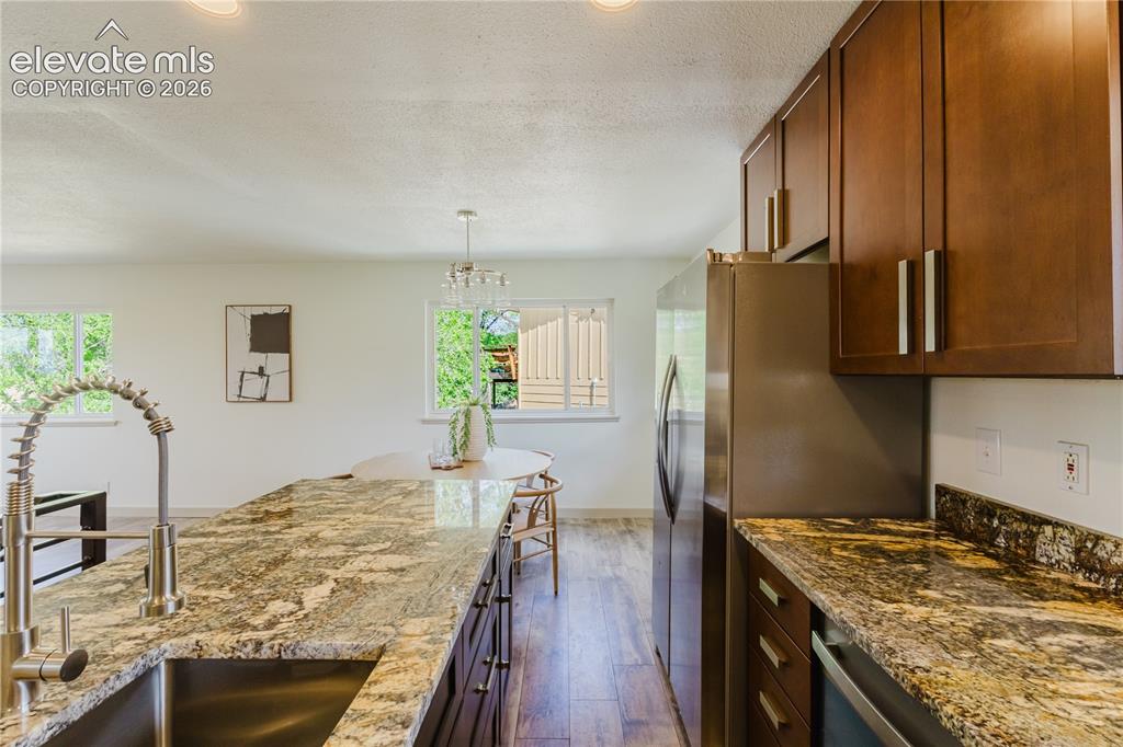 Image 10 of 47: Kitchen featuring wood-finish flooring, recessed lighting, and white walls