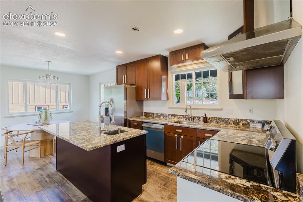 Image 11 of 47: Kitchen featuring wood-finish flooring, recessed lighting, and a stainless