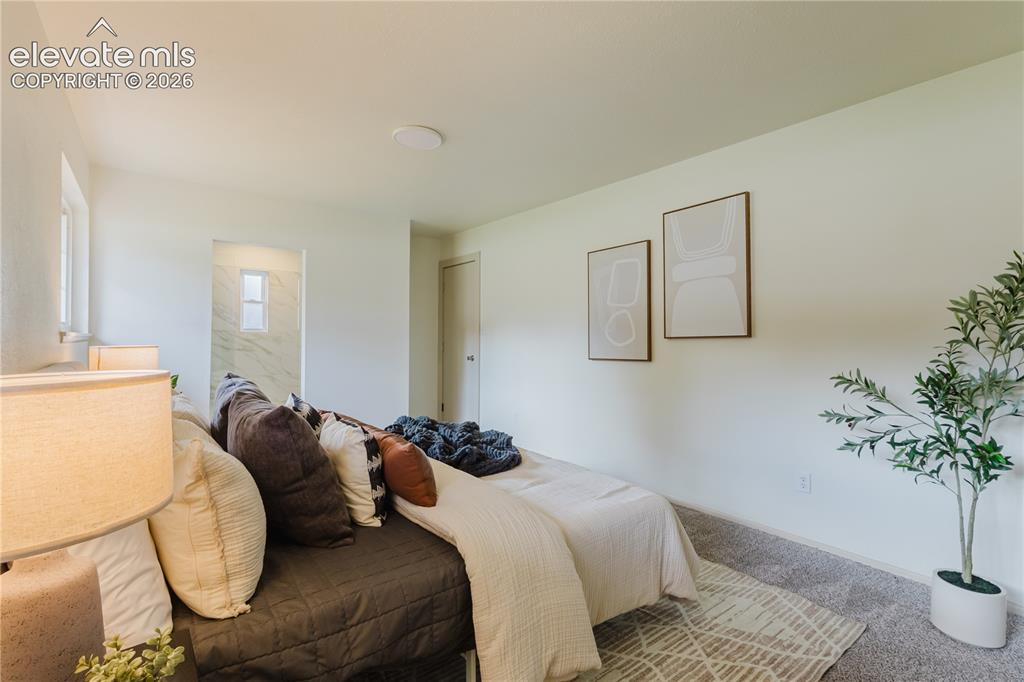 Image 16 of 47: Carpeted bedroom with white walls, recessed ceiling lighting, and two windo