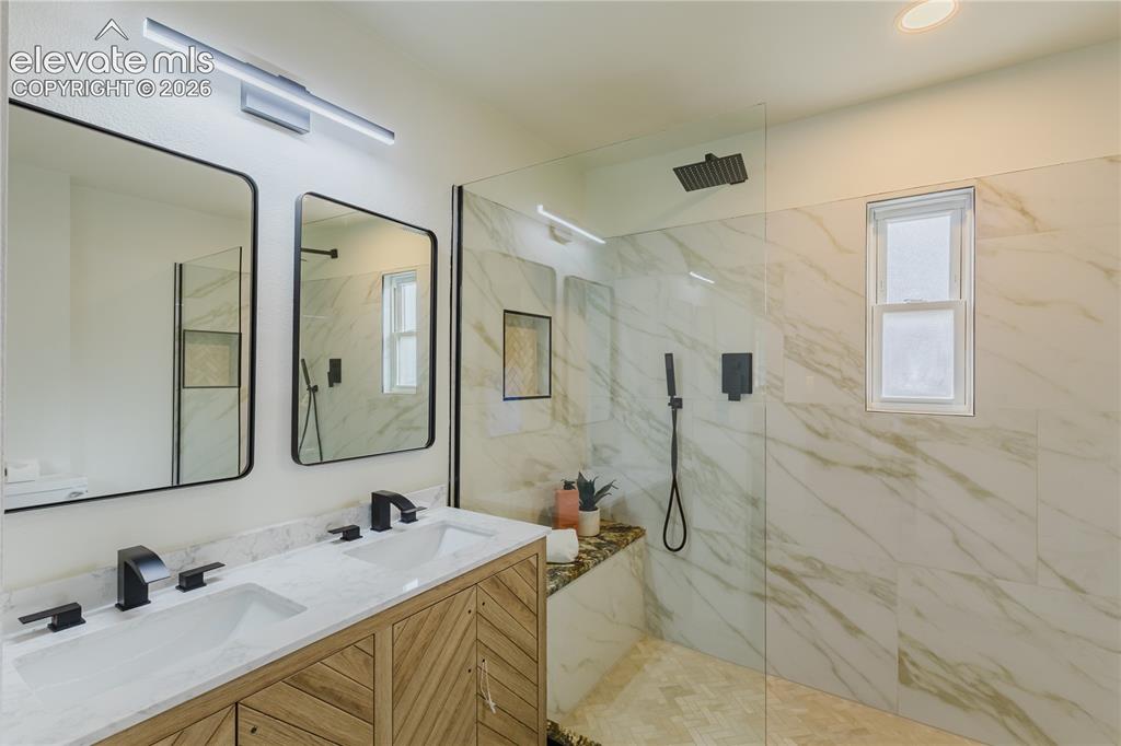 Image 17 of 47: Dual vanity with matte black fixtures and a white countertop