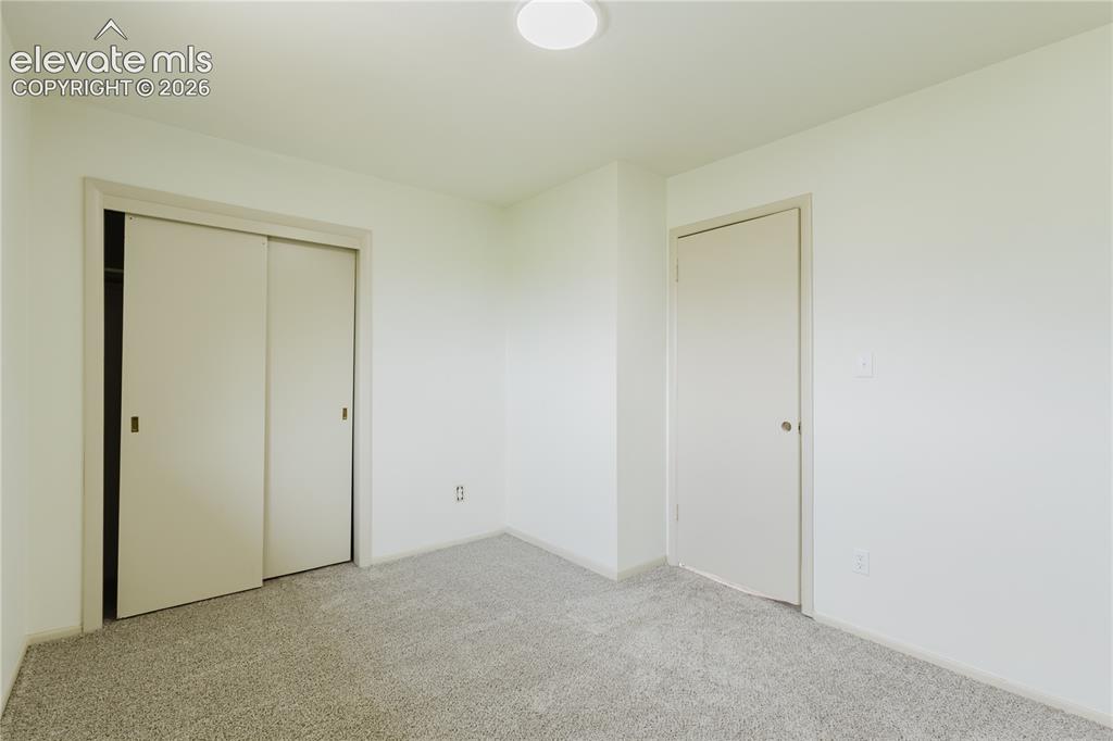 Image 20 of 47: Neutral-toned walls complement the light-colored carpet flooring