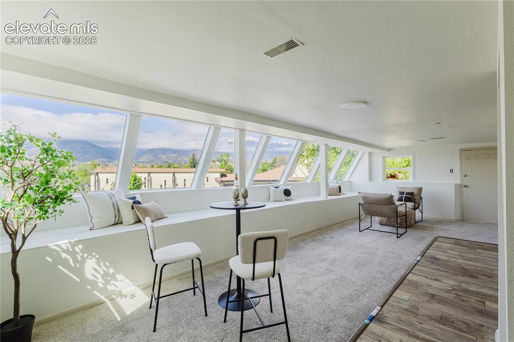 Image 27 of 47: Bright upper-level space featuring a continuous bank of angled windows