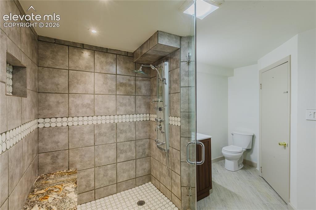 Image 31 of 47: Basement 3/4 Bathroom - Enclosed shower featuring a clear glass door, large