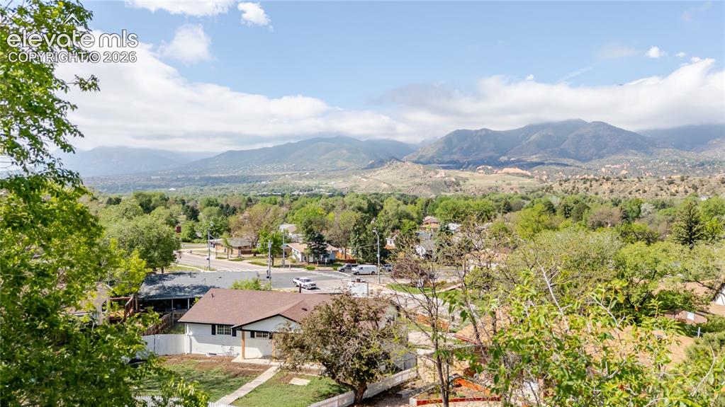 Image 37 of 47: Expansive mountain scenery framing a residential area with varied rooflines
