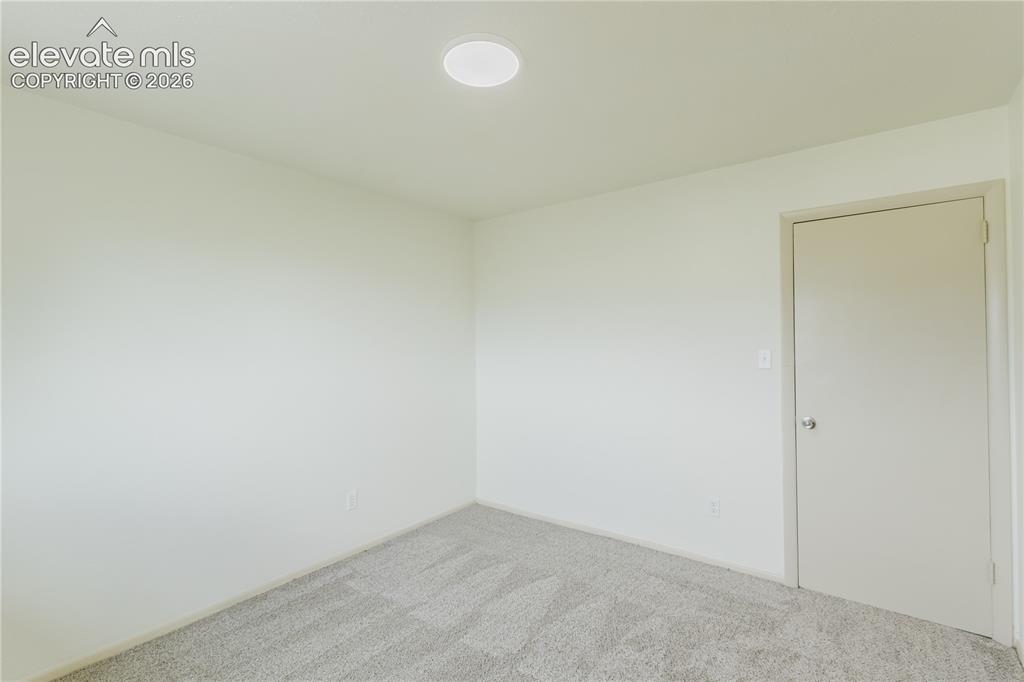 Image 40 of 47: Interior room featuring neutral wall paint, light gray carpeting, a recesse