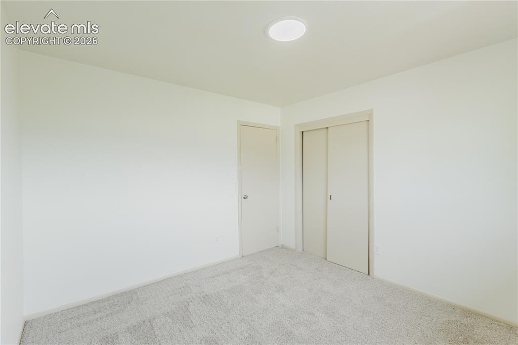 Image 41 of 47: Interior room featuring light-colored carpeting, a recessed ceiling light,