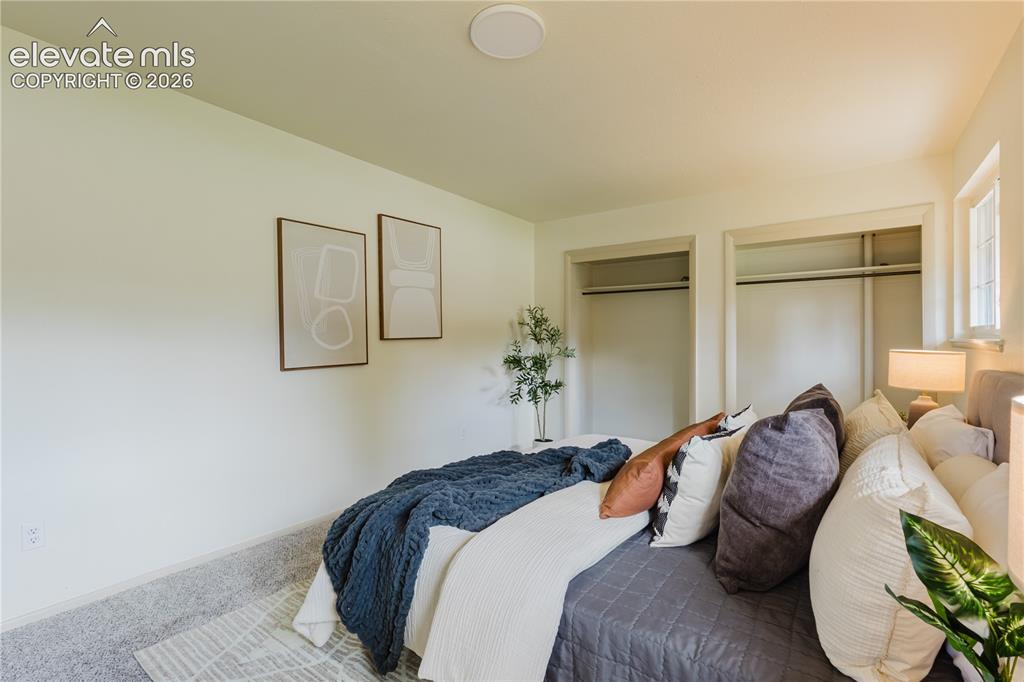 Image 42 of 47: Carpeted bedroom featuring two open closets with hanging rods, recessed cei