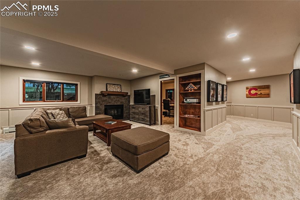 Image 23 of 39: Living area featuring carpet floors, recessed lighting, baseboard heating,