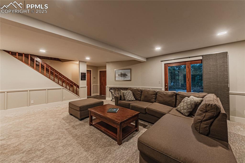 Image 24 of 39: Carpeted living area featuring stairway and recessed lighting