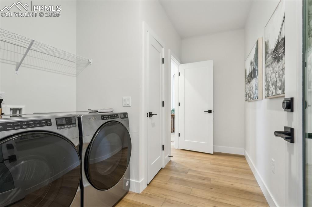 Image 11 of 23: Laundry area featuring laundry area, baseboards, washing machine and dryer,