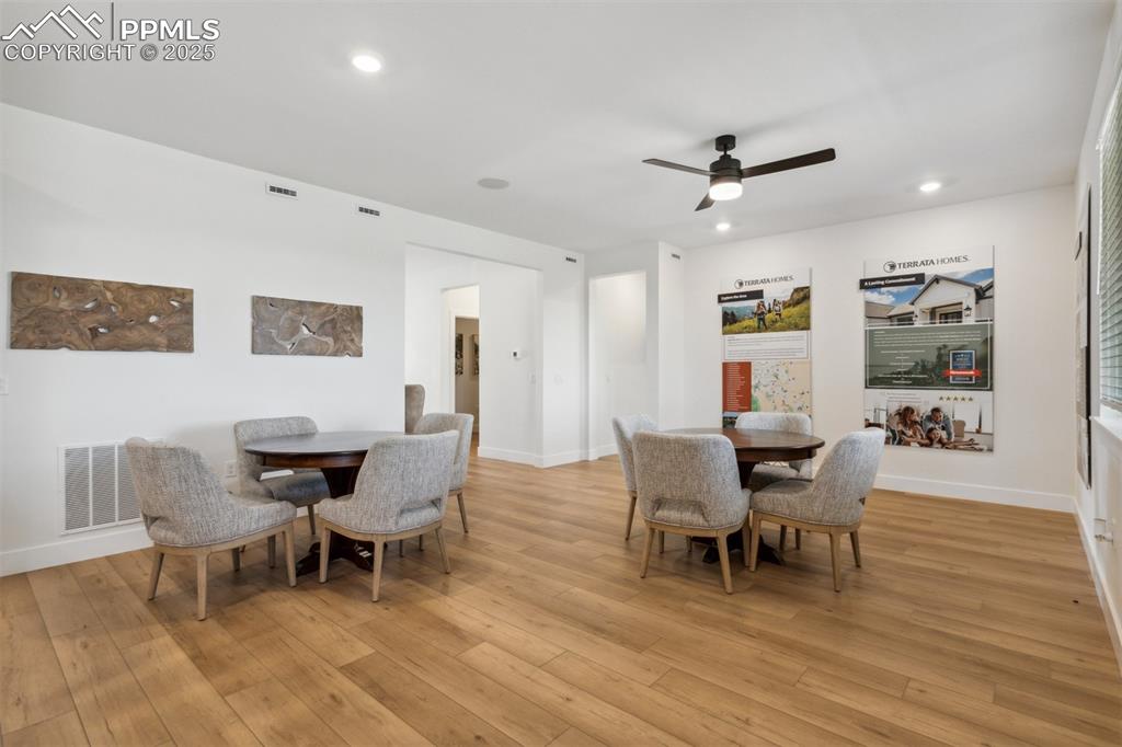 Image 5 of 23: Dining area with light wood-style floors, baseboards, a ceiling fan, and vi