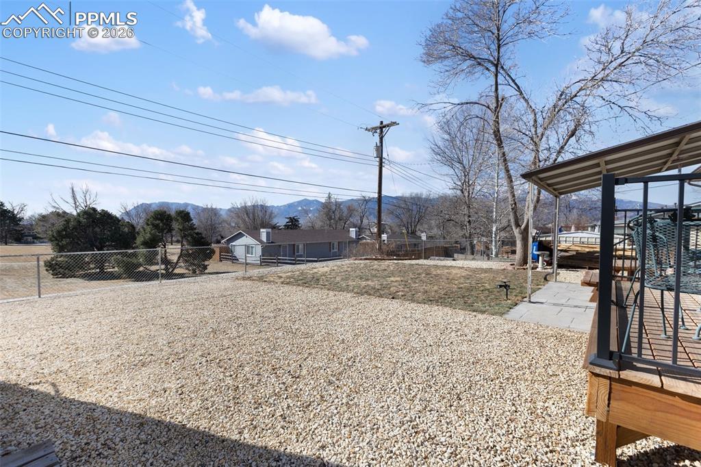 Image 20 of 24: Start your day with coffee on the deck while taking in peaceful park views