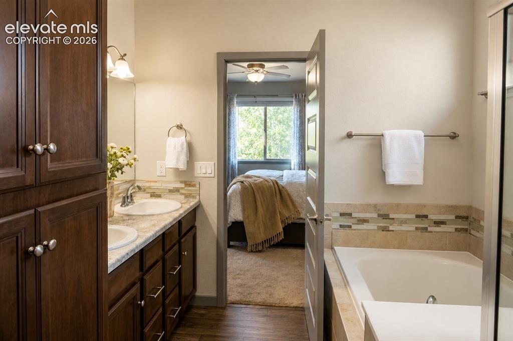 Image 12 of 31: Primary 5-piece Bathroom with free-standing shower and soaking tub