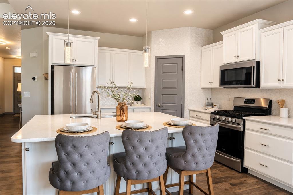 Image 5 of 31: Centrally located kitchen with view of the patio, backyard and open space