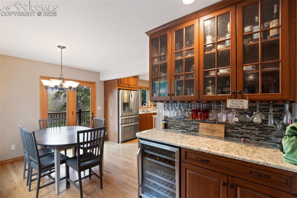Image 18 of 47: Second dining area featuring hardwood flooring and a butlers pantry