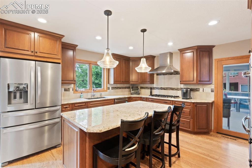 Image 20 of 47: Gourmet kitchen featuring a large island with bar seating, granite countert