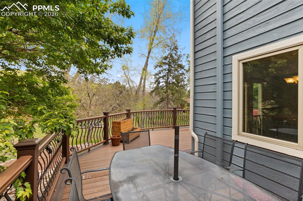 Image 43 of 47: Spacious outdoor deck with dining furniture