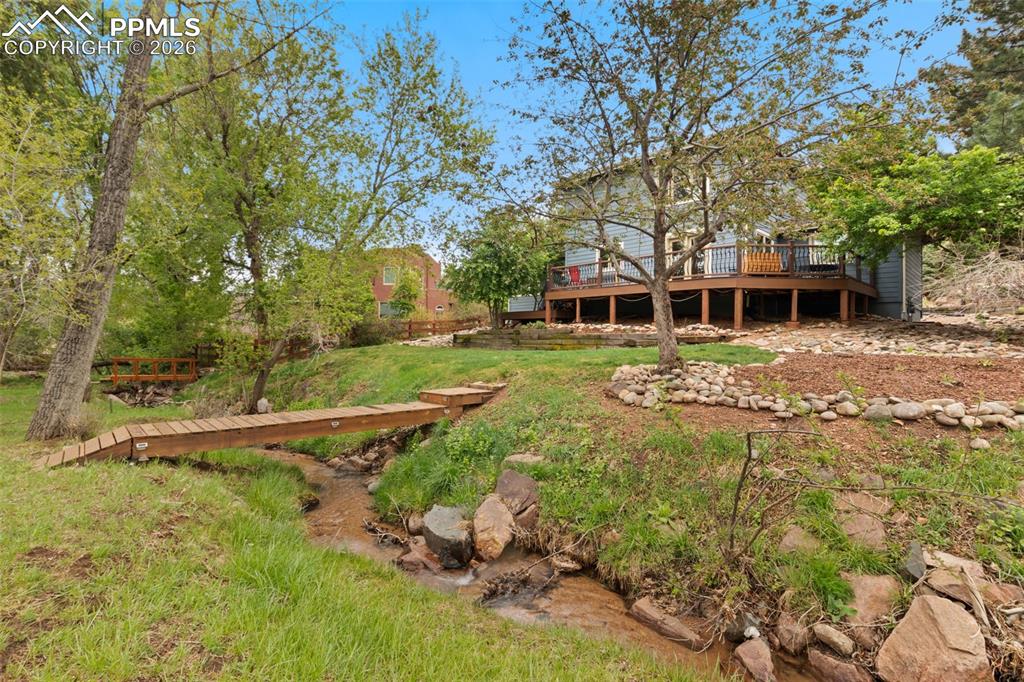 Image 47 of 47: Backyard view of home featuring creek