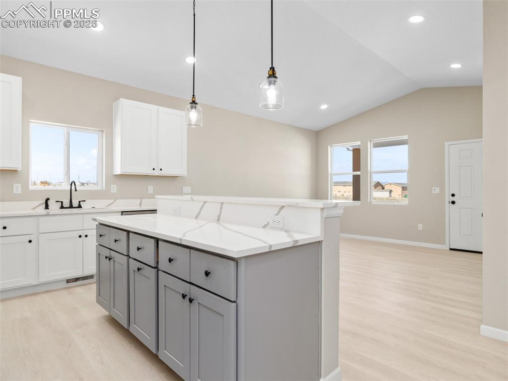 Image 7 of 26: Great bar seating with quartz countertops and custom cabinets perfect for e