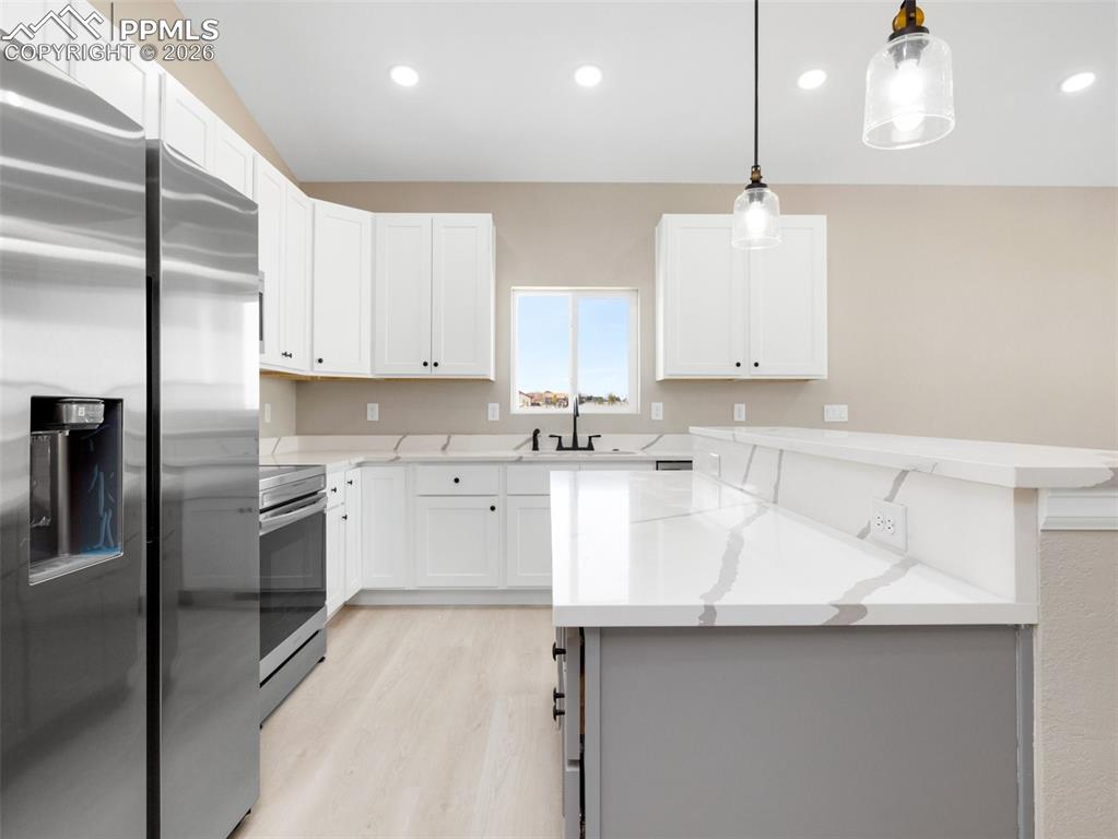 Image 8 of 26: Wonderful kitchen with stainless appliances accented with quartz countertop