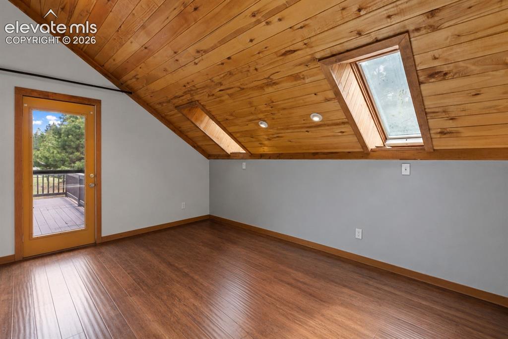 Image 14 of 37: Primary Bedroom with walk out deck.