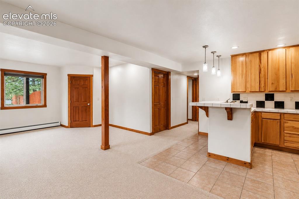 Image 20 of 37: Basement family room and full kitchen