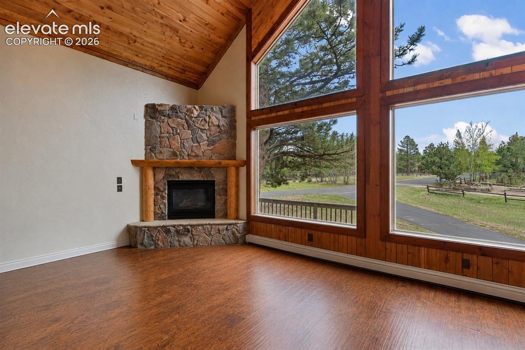 Image 5 of 37: Living room with beautiful light and cathedral windows