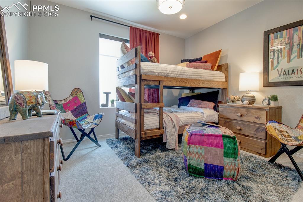 Image 11 of 25: Bedroom featuring light colored carpet and baseboards