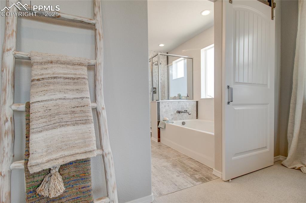 Image 15 of 25: Full bath featuring a garden tub and a stall shower
